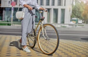 female tourist walking in the famous place of city with bike