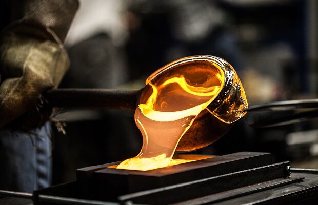 pouring melted glass into graphite mold