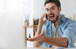 mad executive manager has quarrel with employee over cell phone, dissatisfied with bad report and failure. irritated furious male angry with software bugs in application, can`t continue work