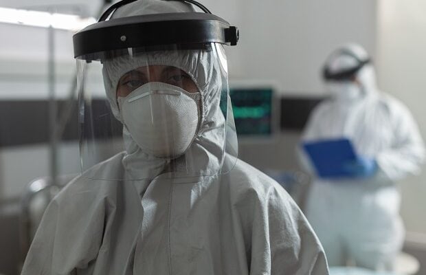medical specialist with face mask dressed in coverall