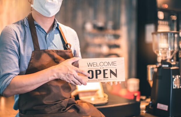 business owner attractive young asian man in apron hanging we're
