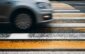 car driving into a pedestrian crossing. motion blur, selective focus. violation of traffic rules, road accident concept