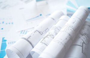 business project documentation, development, planning and approval. construction drawings for building, apartment, financial diagrams, investment plan, documents. making repairs. blurred background