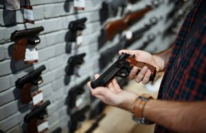 man holds handgun in gun shop