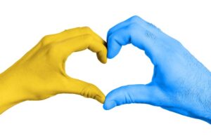 hands forming a heart in colors of national flag of ukraine. isolated on white background with clipping path.