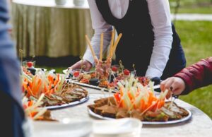 the waiter puts snacks on a buffet