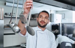 be food safe. cook chooses utensils for cooking in the kitchen of the restaurant