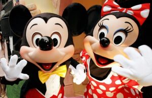 mickey and minnie mouse wave to celebrat