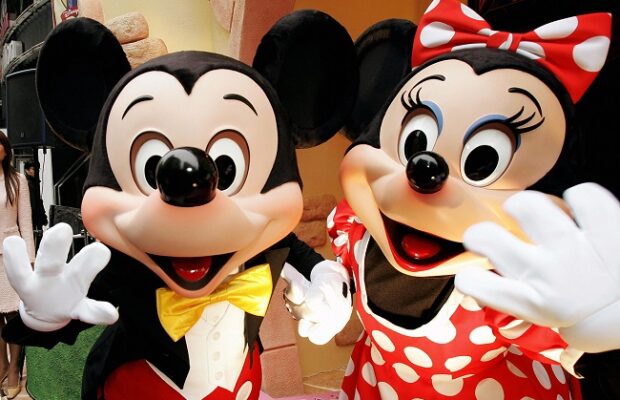 mickey and minnie mouse wave to celebrat