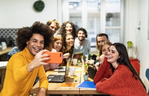 young people taking selfie with mobile smartphone in co working