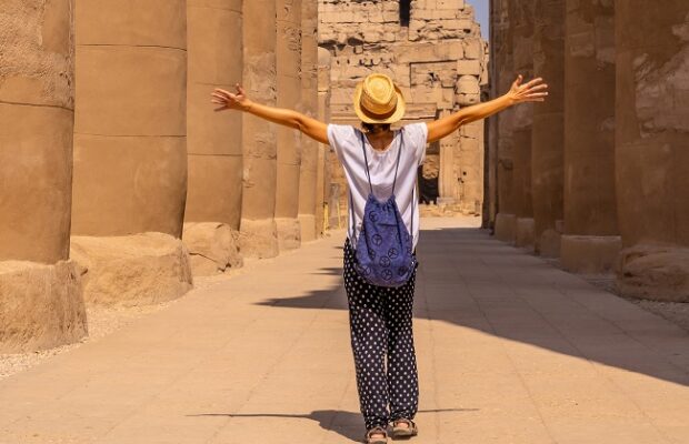 woman tourist wearing a hat visiting the egyptian temple of luxor. egypt