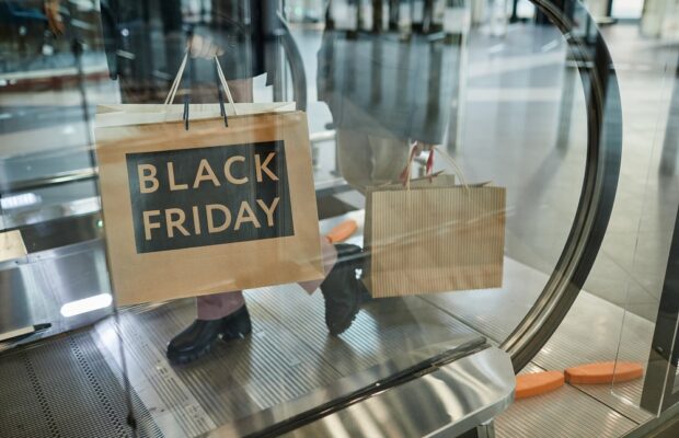 woman holding black friday shopping bags
