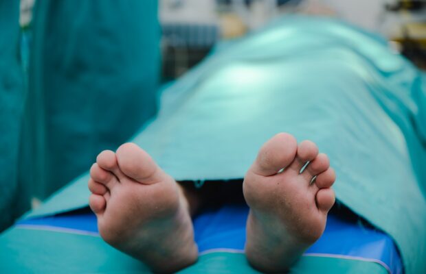 corpse foot on hospital table, health care medicine concept and life death insurance