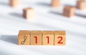 112 emergency concept. wooden dices with phone icon and 112 text