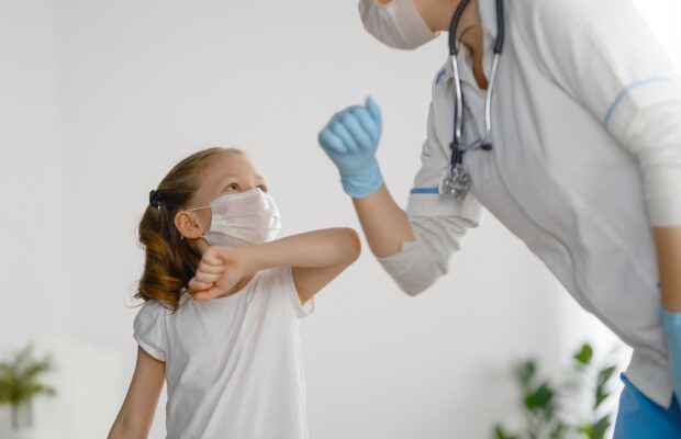 doctor and child wearing facemasks