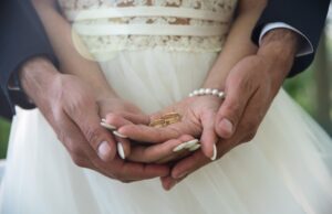 two golden wedding rings on bride and groom's palms. wedding rin