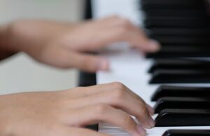 child hand on piano keys