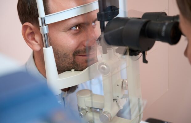 confident male is receiving qualified consultation in ophthalmology clinic